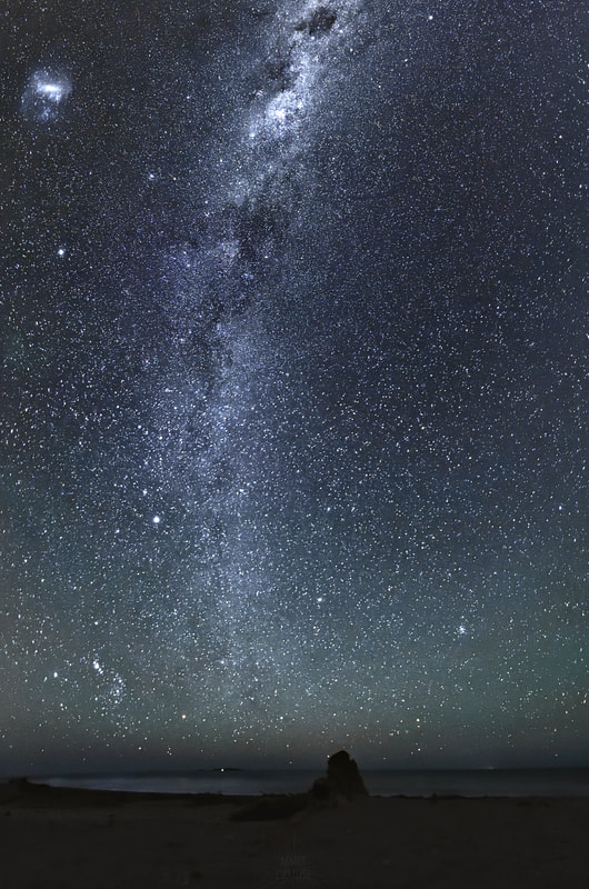 Ciel nocturne boréal : la Voie Lactée et les nuages de Magellan, côte ouest de la Nouvelle-Zélande.