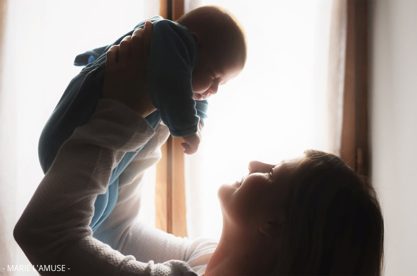 Photoshoot naissance, maman et bébé en contre jour devant une fenêtre, Thonon Haute Savoie 2021, Photographe Marie l'Amuse