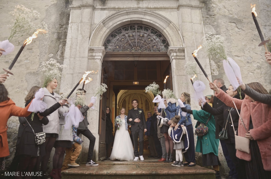 Mariage hivernal, Cérémonie, Sortie des mariés aux flambeaux à l'église, Bellevaux Haute Savoie 2019, Photographe Marie l'Amuse
