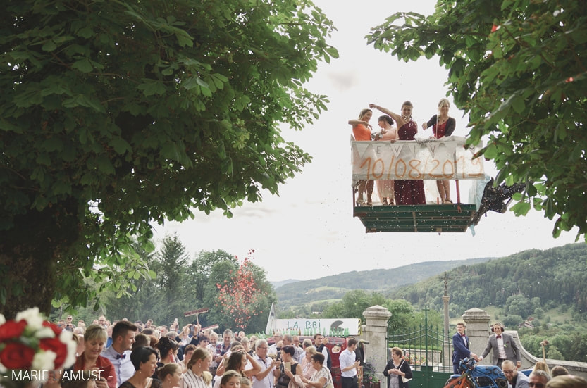 Mariage religieux, sortie d'église, les témoins jettent des confettis depuis une plateforme suspendue au dessus des invités. Habère-Poche Vallée Verte, Haute-Savoie