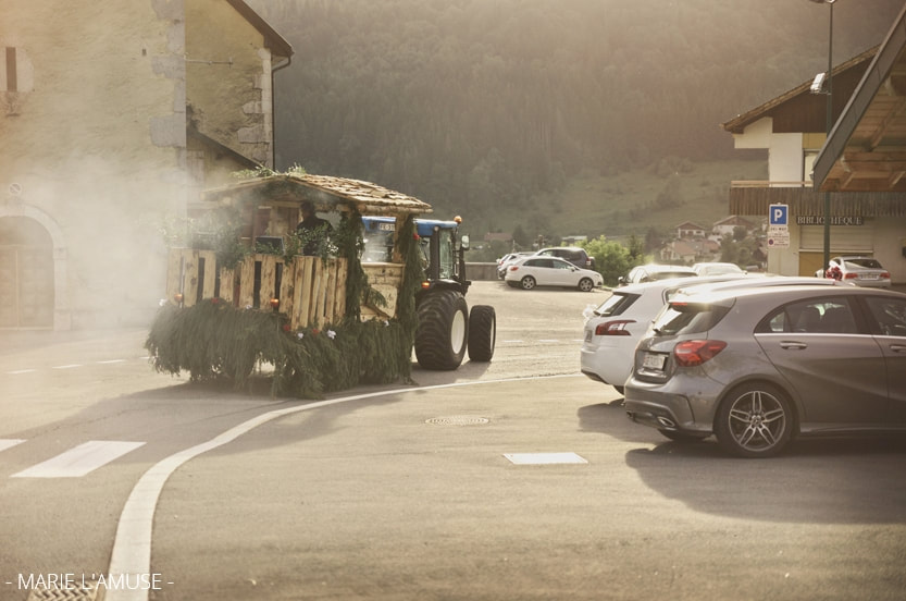 Vin d'honneur, un tracteur tirant un char en bois recouvert de branche arrive en fumant. Mariage Habère-Poche Vallée Verte, Haute-Savoie
