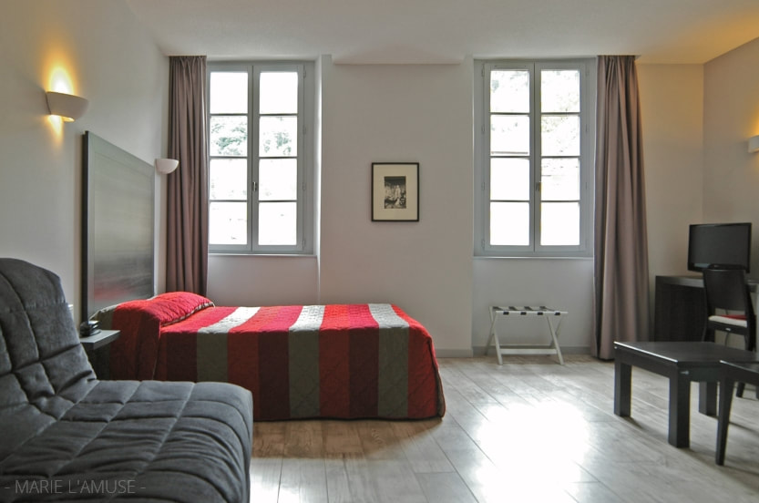 Reportage professionnel, hôtel, Chambre moderne au lit rouge noir gris, France, Photographe Marie l'Amuse
